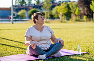 Young woman sitting on field