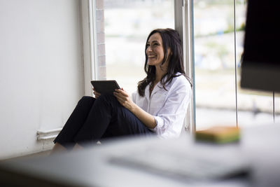 Businesswoman working barefoot on floor