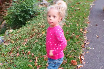 High angle view of cute girl standing by plants
