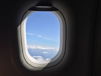 Cloudy sky seen through airplane window