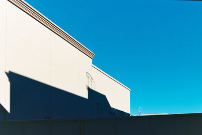 Low angle view of building against clear blue sky