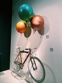 Low angle view of balloons against wall in building