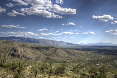 Scenic view of mountains against cloudy sky