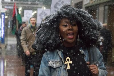 Portrait of a young woman in protest march in snow