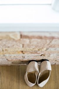 Close-up of shoes on beach