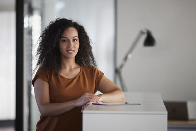 Businesswoman with tablet pc on desk in office