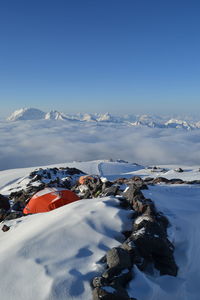 Snow covered mountain against blue sky