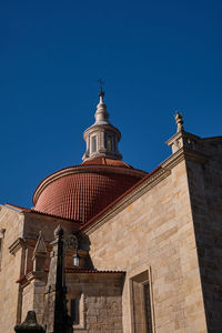 Low angle view of church against clear blue sky