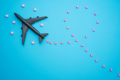 High angle view of multi colored balls on table against blue background