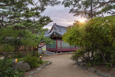 Temple by building against sky