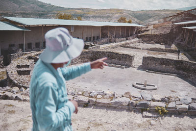 Group of tourists listening the guide explanation about wari archaeological complex, ayacucho. peru