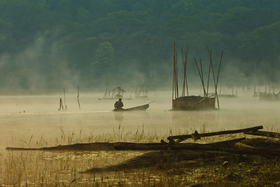 Scenic view of foggy lake