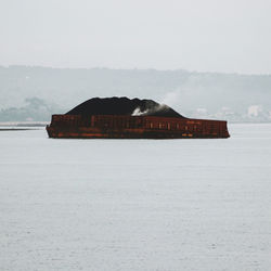 House by sea against sky