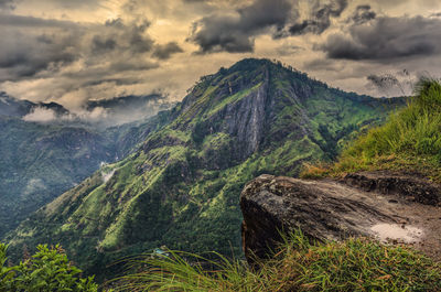 Scenic view of mountains against cloudy sky