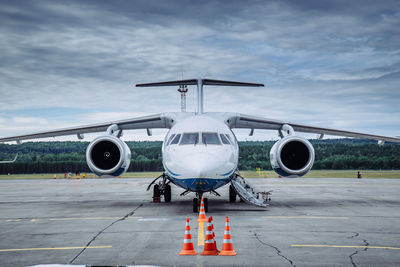 Airplane on runway against sky