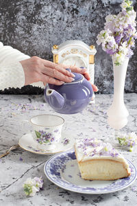 Still life with black tea and cheese cake, spring bouquet,delicate lilac flowers