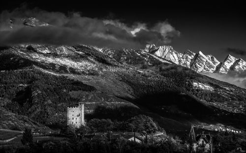 Panoramic shot of building and mountains against sky