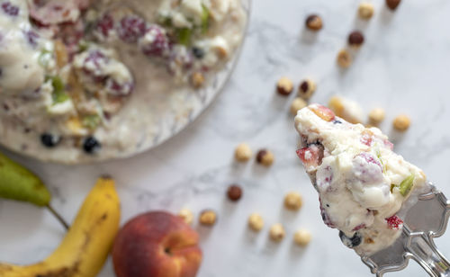 Dessert knife with a portion of pudding with fruit and nuts.