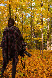 Rear view of a man walking in forest