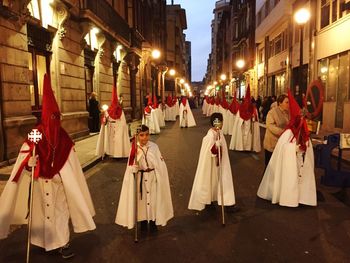 Panoramic view of people on street at night