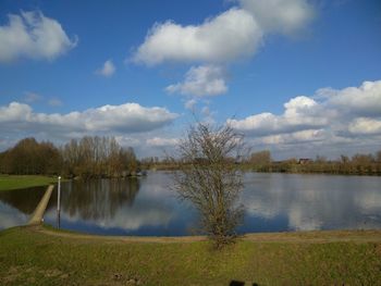 Scenic view of lake against cloudy sky