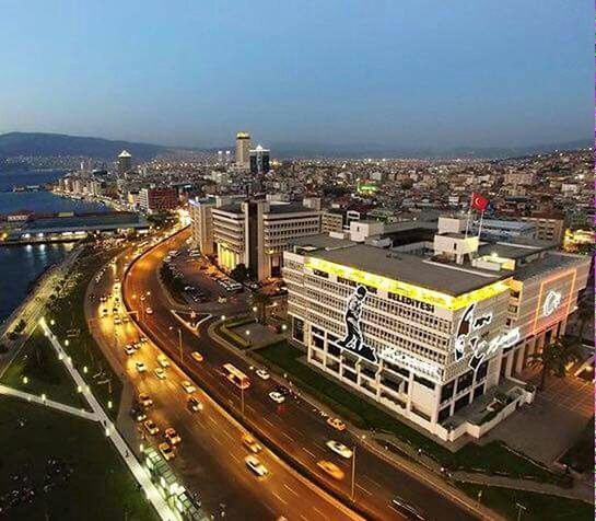 transportation, high angle view, city, architecture, building exterior, mode of transport, car, built structure, cityscape, road, traffic, land vehicle, illuminated, city life, street, highway, on the move, travel, road marking, elevated view