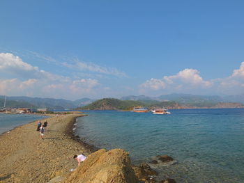 People on beach against sky