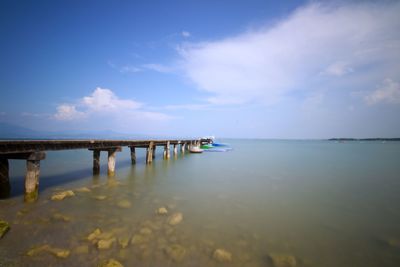 Pier over sea against sky