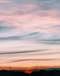 Scenic view of silhouette city against sky during sunset