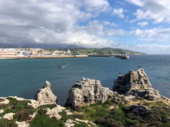 Scenic view of rocks and sea against sky