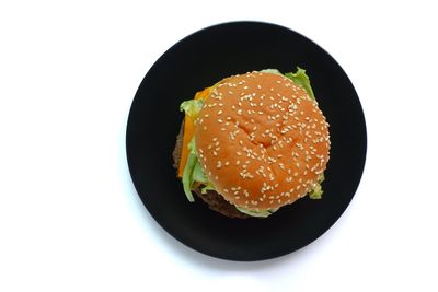 Close-up of burger in plate against white background