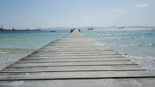 Pier over sea against sky