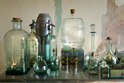 High angle view of glass bottles on table against wall