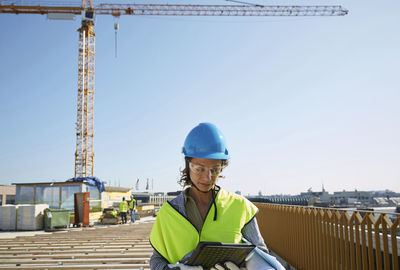 Portrait of man wearing construction site against sky