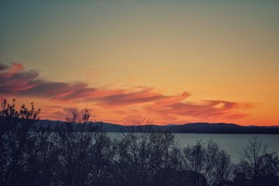 Scenic view of lake against romantic sky at sunset