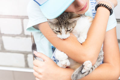 The child gently holds the cat in his arms. the concept of love for pets. animal assisted therapy. 