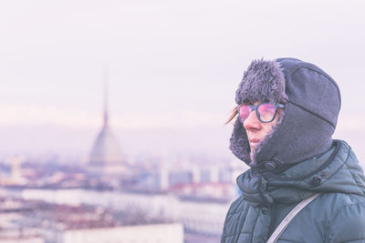 Young woman wearing hat against clear sky