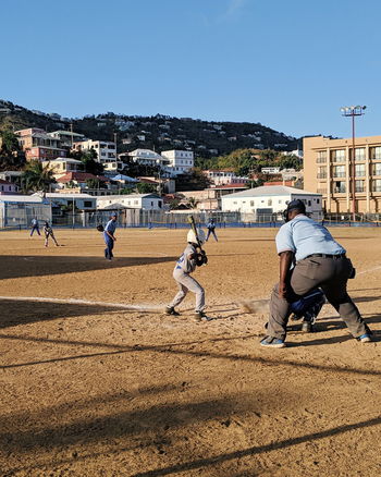 PEOPLE PLAYING SOCCER AGAINST CLEAR SKY