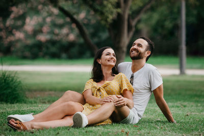 Happy couple relaxing at park