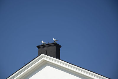 Low angle view of building against clear blue sky