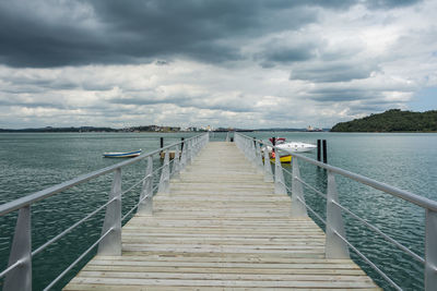 Pier over sea against sky