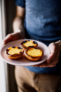 Midsection of man holding food in plate