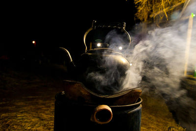 Smoke emitting from teapot at night