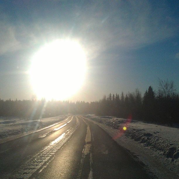 snow, winter, cold temperature, sun, transportation, road, the way forward, sunbeam, season, weather, sky, sunlight, lens flare, covering, sunset, diminishing perspective, vanishing point, nature, tranquility, landscape