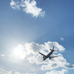 Low angle view of airplane flying in sky