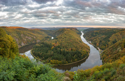 Scenic view of river amidst trees against sky