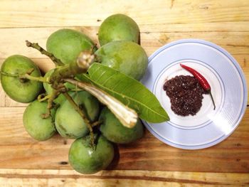 Directly above shot of mangoes with pickle and chili on table