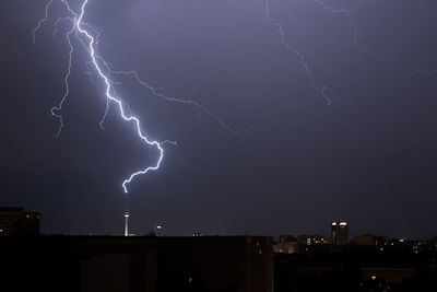 Lightning in sky over city at night