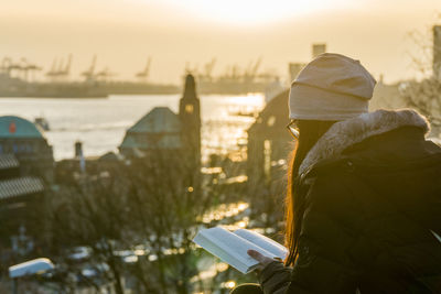 Close-up of cross against buildings in city