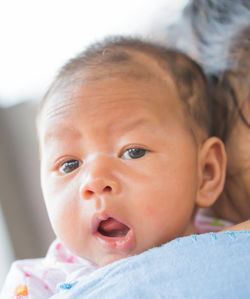 Midsection of mother carrying toddler son